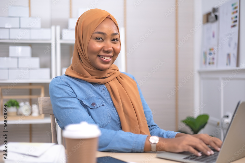 Smiling African female business owner using digital tablet and talking on the phone .Online shopping and start up concept. Smiling African female business owner using digital tablet and talking on the phone .Online shopping and start up concept.