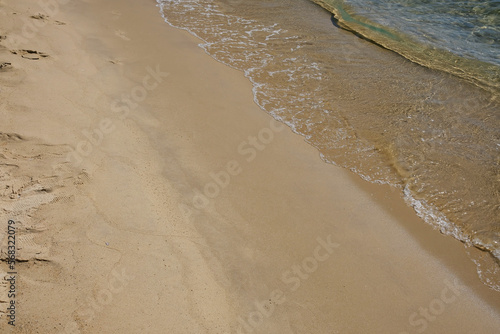 The golden sandy beach and the clear waters of Mylopotas in Ios Cyclades Greece photo