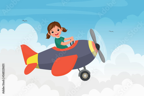 cute little girl flying an airplane in the blue sky © Tenstudio