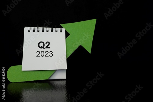 Obraz na płótnie Second quarter of 2023 positive growth performance financial report and fiscal concept. Upward arrow with increasing coins and calendar in black background. w salonie