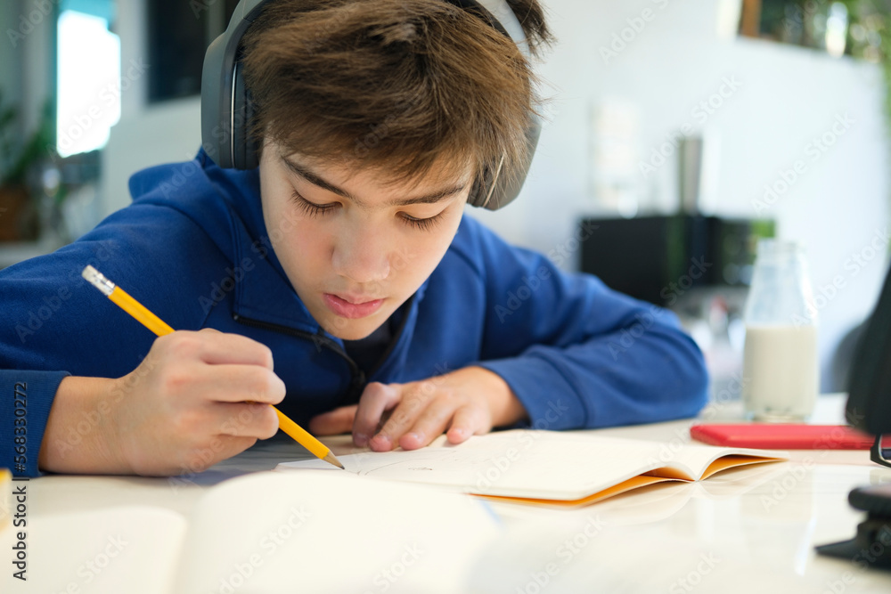 Student boy with tablet computer learning at home Student boy with tablet computer learning at home