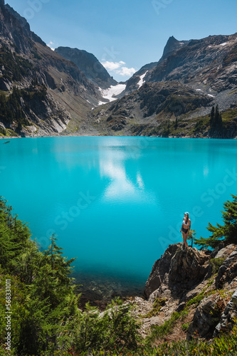 Fit Female Standing Next To Beautiful Turquoise Alpine Lake photo