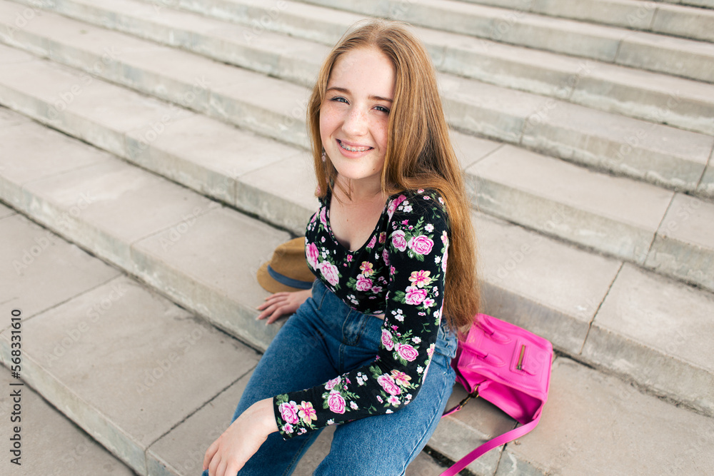 © Cavan Images - Teenage girl lying on the stairs with accessories