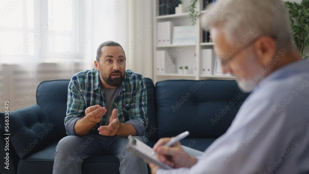 Man with traumatic experience talking with professional psychologist, therapy Man with traumatic experience talking with professional psychologist, therapy