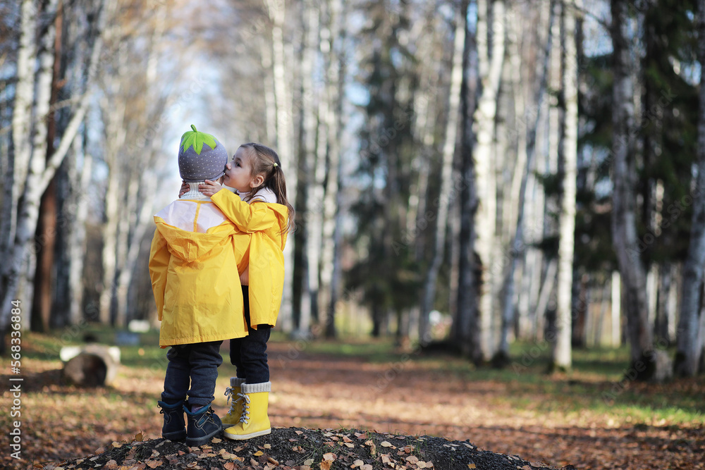 Children walk in the autumn park Children walk in the autumn park