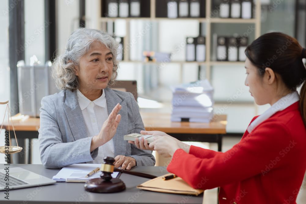 lawyer working with contract agreement at table office, lawyer holding money and justice concept, Selective focus. lawyer working with contract agreement at table office, lawyer holding money and justice concept, Selective focus.