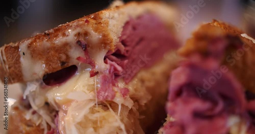 Triple-decker Ruben corned beef sandwich extreme close-up melted cheese rye