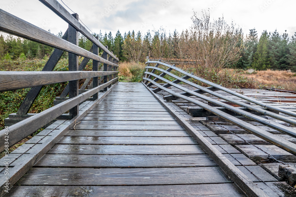 Obraz premium An old, rotten wooden bridge over the Owenea river by Ardara in County Donegal - Ireland