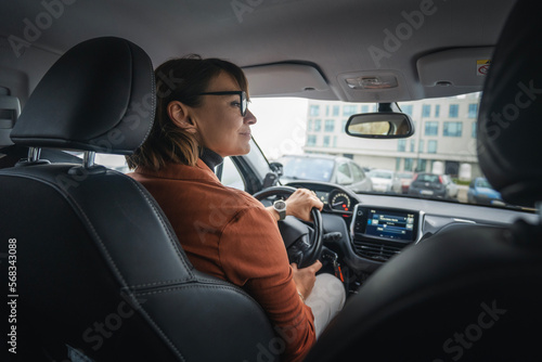Adult caucasian businesswoman in glasses driving a car © olezzo