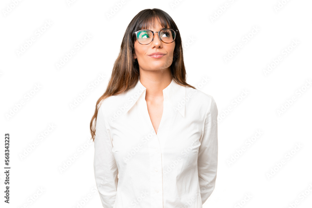 Young caucasian woman over isolated chroma key background and looking up Young caucasian woman over isolated chroma key background and looking up