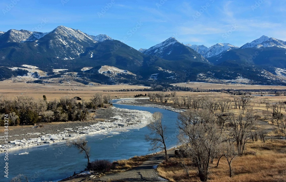 scenic winter landscape on a sunny day  at mallard's rest fishing access along the paradise valley scenic loop of the yellowstone river and gallatin range, south of livingston, montana