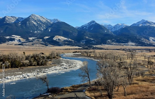 scenic winter landscape on a sunny day  at mallard's rest fishing access along the paradise valley scenic loop of the yellowstone river and gallatin range, south of livingston, montana photo