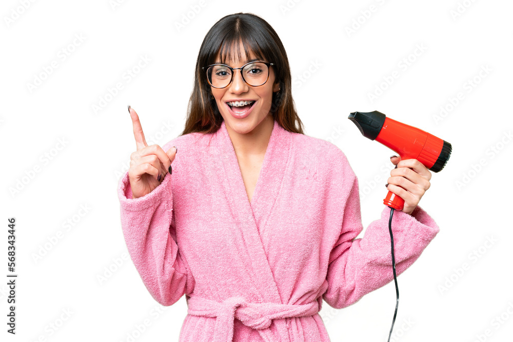Young caucasian man holding a hairdryer over isolated chroma key background pointing up a great idea Young caucasian man holding a hairdryer over isolated chroma key background pointing up a great idea