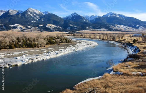 scenic winter landscape on a sunny day at mallard's rest fishing access along the paradise valley scenic loop of the yellowstone river and gallatin range, south of livingston, montana