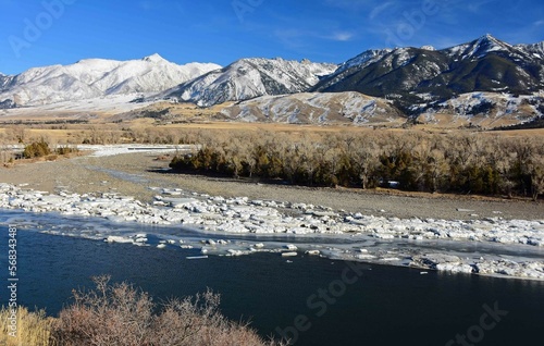 scenic winter landscape on a sunny day  at mallard's rest fishing access along the paradise valley scenic loop of the yellowstone river and gallatin range, south of livingston, montana photo