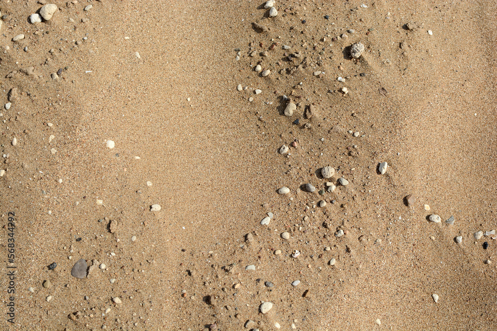texture of a sandy beach with small pebbles. sand background texture of a sandy beach with small pebbles. sand background