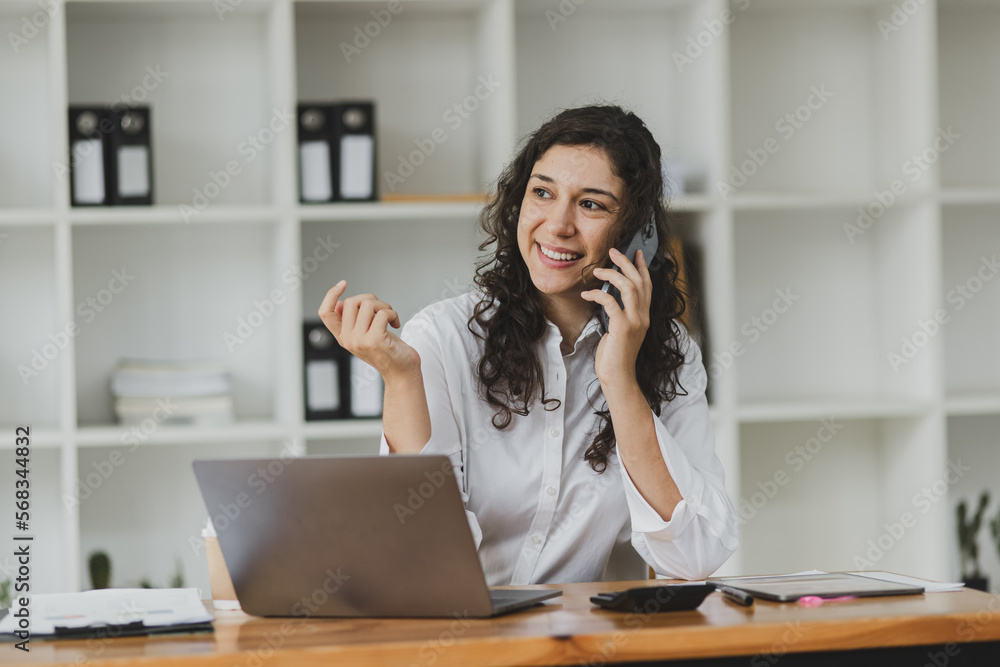 Businesswoman using smartphone sitting at desk in office. Digital marketing concept. Businesswoman using smartphone sitting at desk in office. Digital marketing concept.