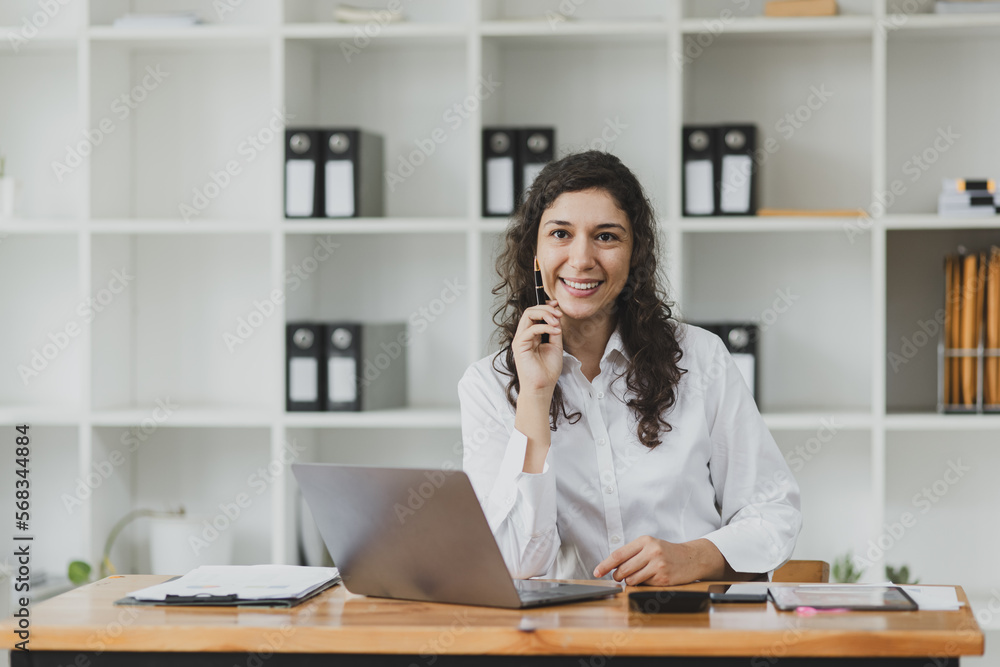 Businesswoman using laptop sitting at desk in office. Digital marketing concept. Businesswoman using laptop sitting at desk in office. Digital marketing concept.