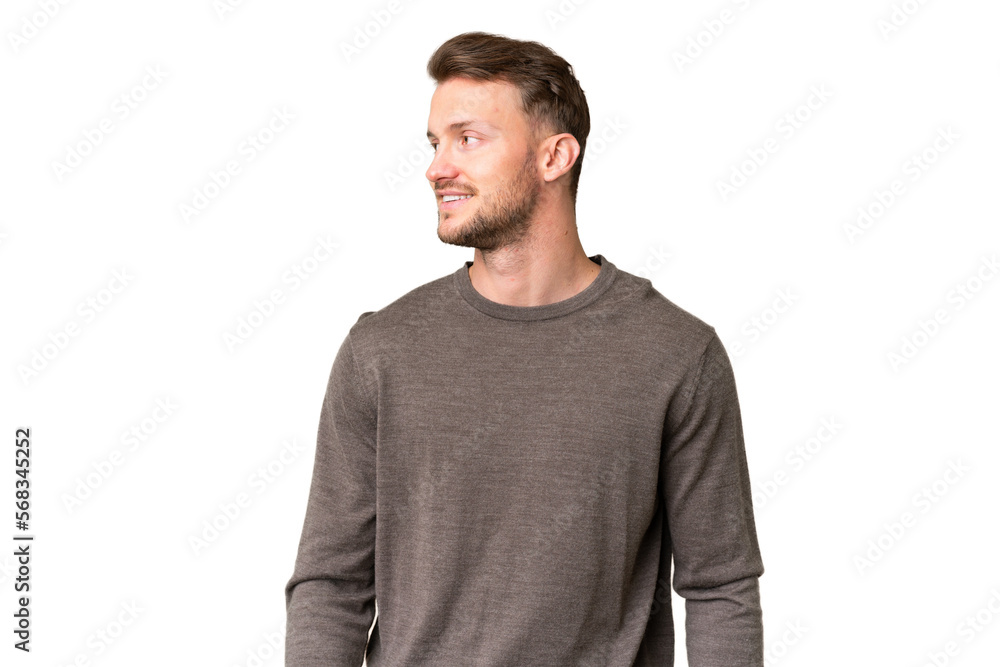 Fototapeta premium Young handsome caucasian man over isolated chroma key background looking to the side and smiling