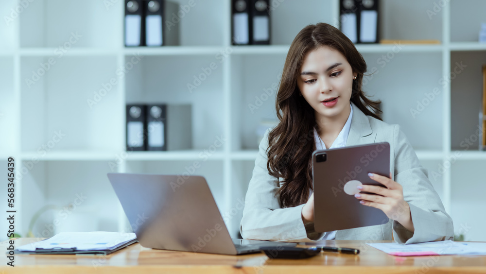 Portrait of young business woman working on laptop, Portrait of young business woman working on laptop,