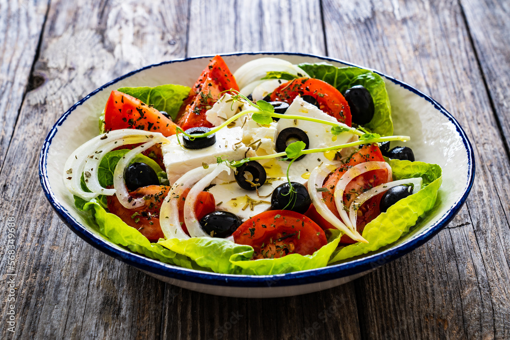 Fresh vegetable salad with feta cheese on wooden table
Fresh vegetable salad with feta cheese on wooden table