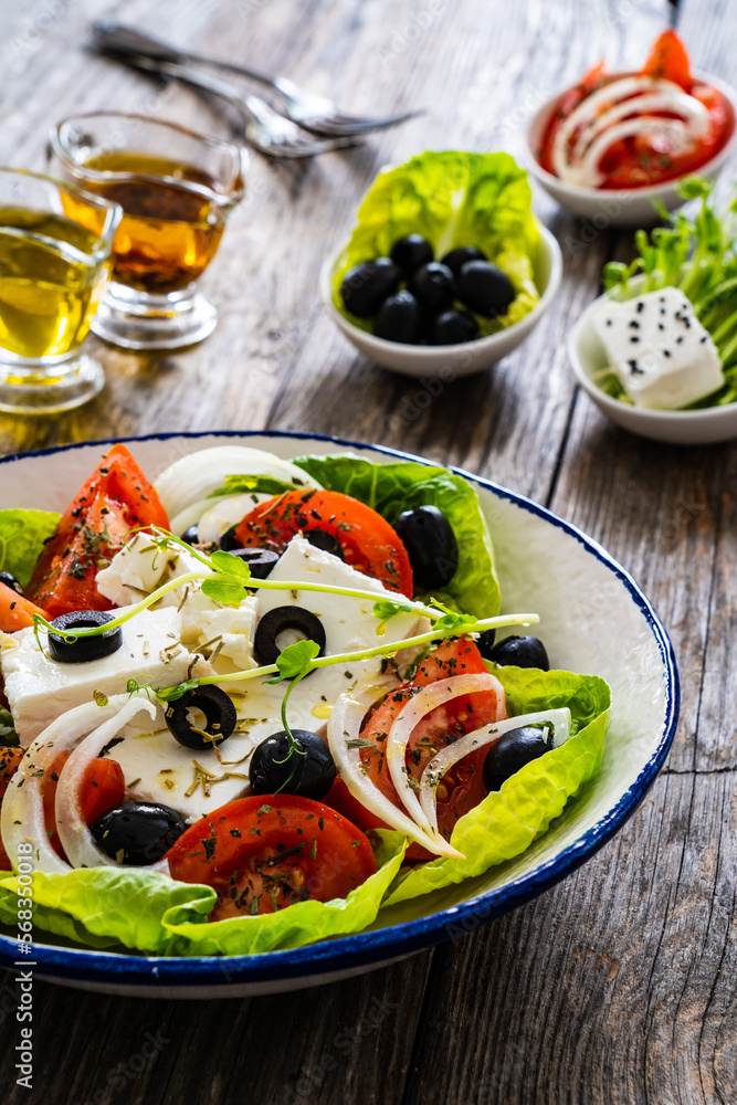 Fresh vegetable salad with feta cheese on wooden table
Fresh vegetable salad with feta cheese on wooden table