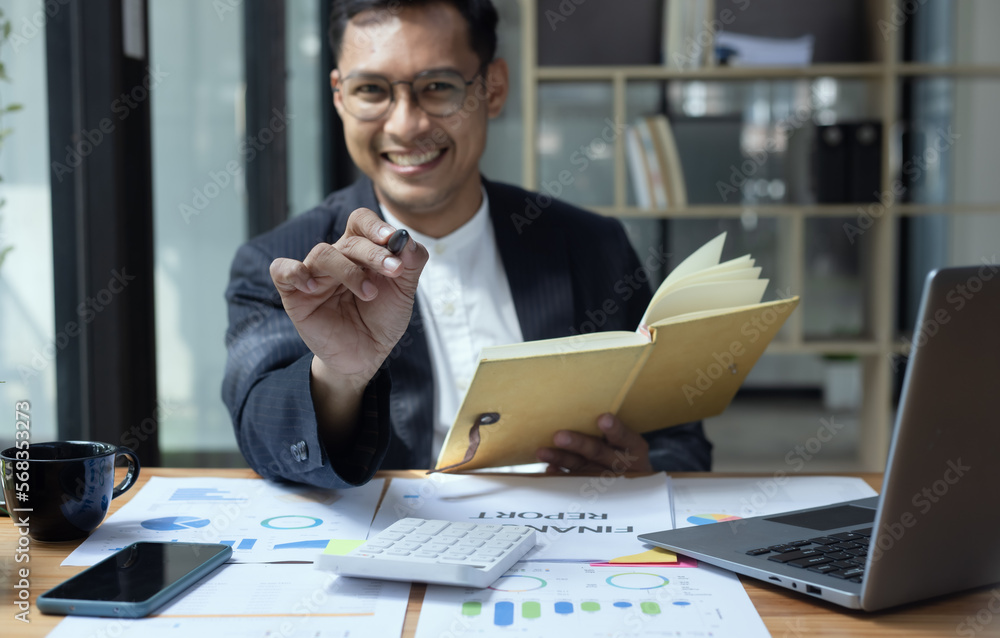 Happy Asian man working online sitting at desk in office, freelance business, Asian man happy and smile face. Happy Asian man working online sitting at desk in office, freelance business, Asian man happy and smile face.