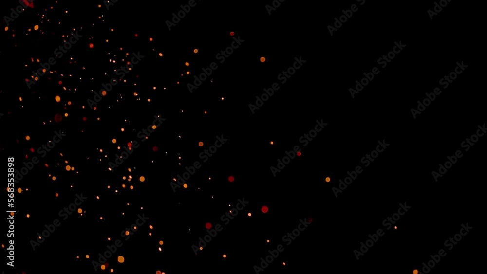 Burning red hot sparks rise from large fire in the night sky Burning red hot sparks rise from large fire in the night sky