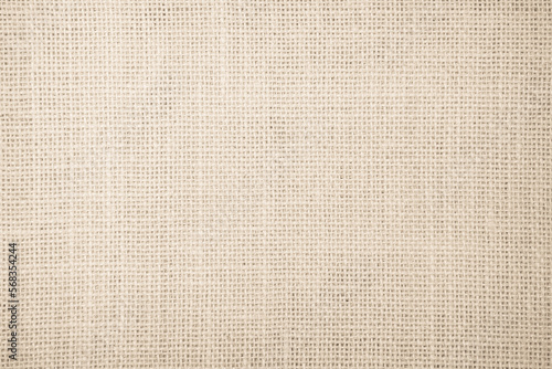 Jute hessian sackcloth burlap canvas woven texture background pattern in light beige cream brown color. Natural weaving fiber linen and cotton cloth texture.
