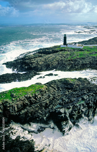 Stormy Atlantic weather. Slyne Head lighthouse marks the treacherous rocks of at southwest tip of Connemara, County Galway, Ireland. Aerial photo