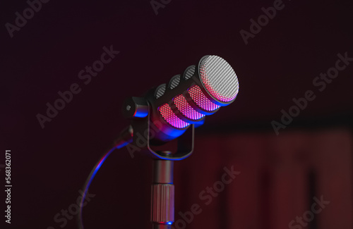 Pod Mic on Table in dark studio recording room with Red and Blue highlights