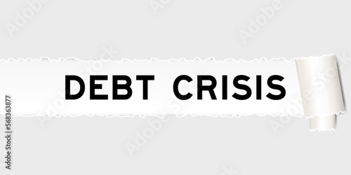Ripped gray paper background that have word debt crisis under torn part
