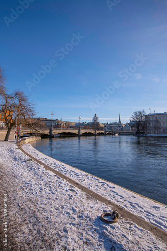 Pier foot path way, the bridge Vasabron and the old town Gamla Stan a sunny snowy winter day in Stockholm © Hans Baath