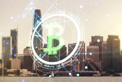 Double exposure of creative Bitcoin symbol hologram on San Francisco office buildings background. Mining and blockchain concept