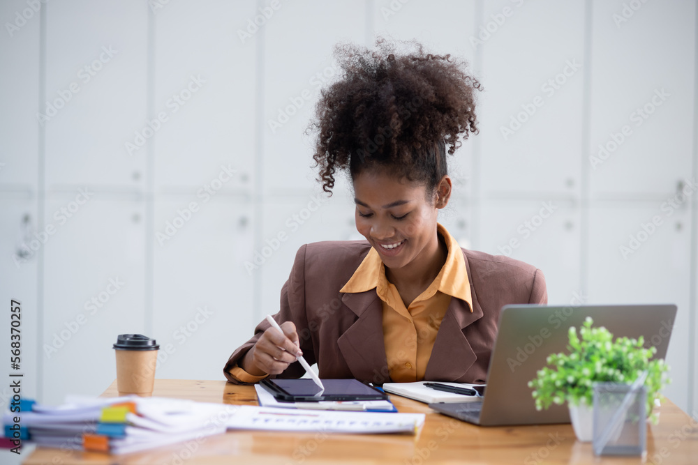 Young African American businesswoman working with pile of documents at office workplace, business finance and accounting concepts. Young African American businesswoman working with pile of documents at office workplace, business finance and accounting concepts.
