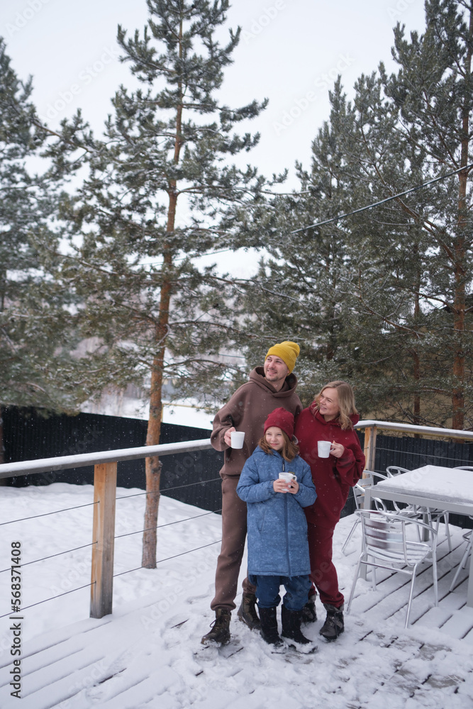 Portrait of happy family outdoors on winter day