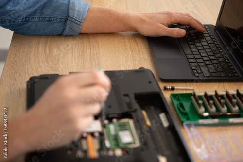 an engineer performing laptop maintenance