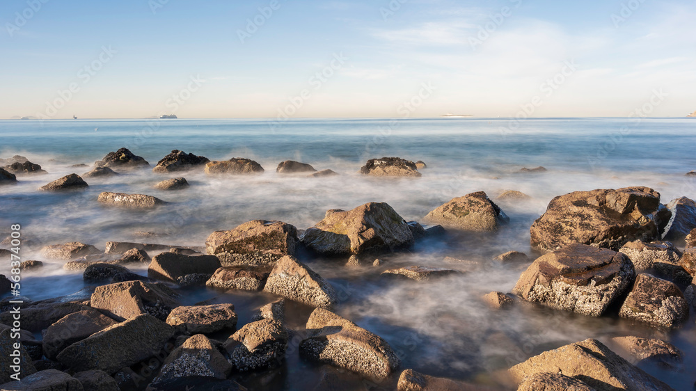 Rocks on the shoreline of a California Beach. Long Exposure so the sea is smooth. Room for Copy.