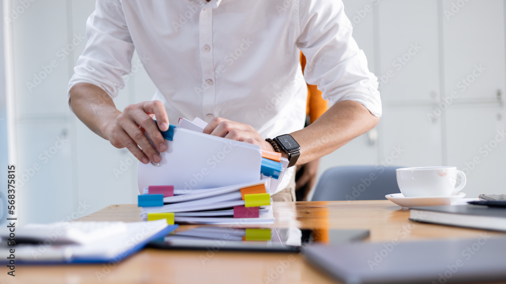 Hands of business working with Stacks of paper files for searching, document on folders papers at desk office. Hands of business working with Stacks of paper files for searching, document on folders papers at desk office.