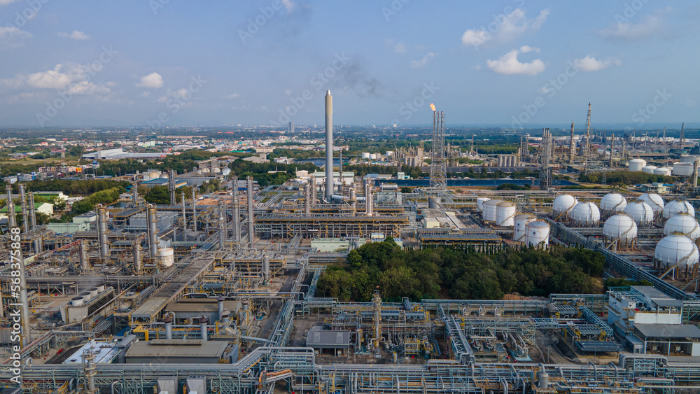 Industrial oil and gas refinery plant form industry zone and 0il storage at sunset.