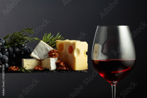Red wine with cheese, walnuts, grapes, and rosemary.