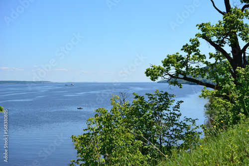 Fototapeta Naklejka Na Ścianę i Meble -  the widest place of Volga river with blue sky, view from the top of the hill with green trees