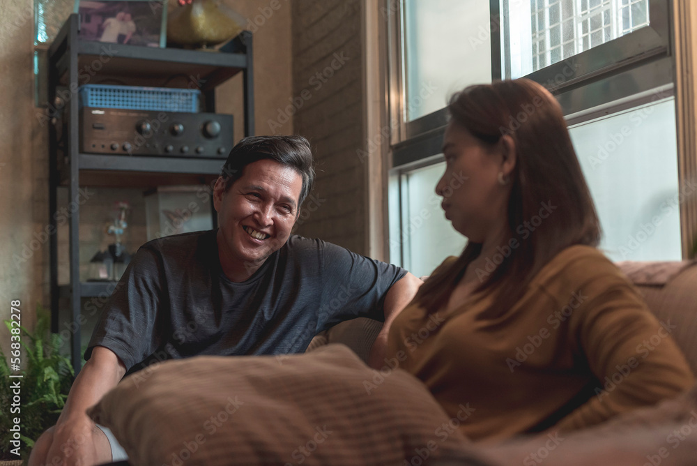 An asian woman is not amused at her husband's inappropriate or misogynistic jokes. Martial problems and disagreements in a couple. An asian woman is not amused at her husband's inappropriate or misogynistic jokes. Martial problems and disagreements in a couple.