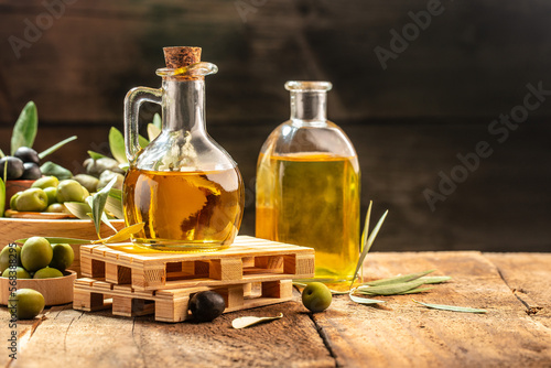 extra virgin olive oil in glass bottles on a wooden background. Healthy and detox food concept. place for text