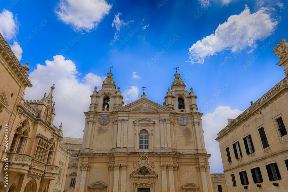 Saint Paul and Peter Cathedral in Mdina, Malta. Roman Catholic church under cloudy sky background.