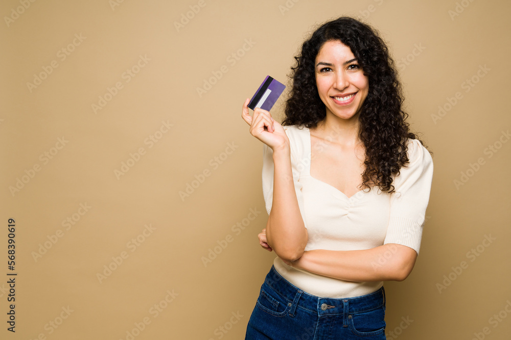 Excited woman holding a new credit card Excited woman holding a new credit card