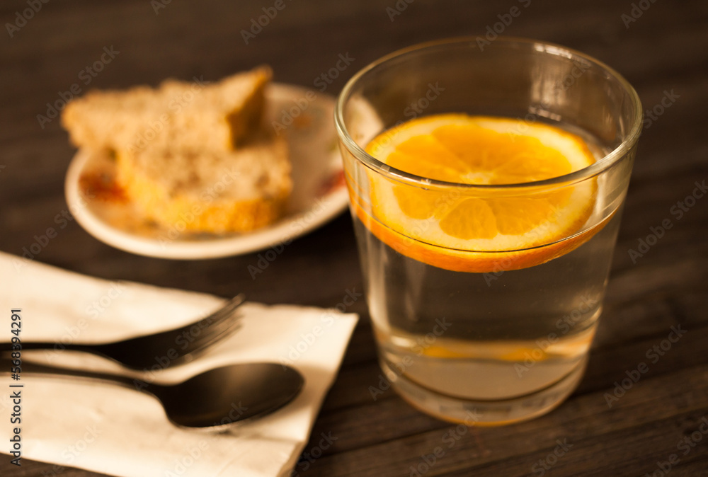 slice of orange in glass of water on the table slice of orange in glass of water on the table