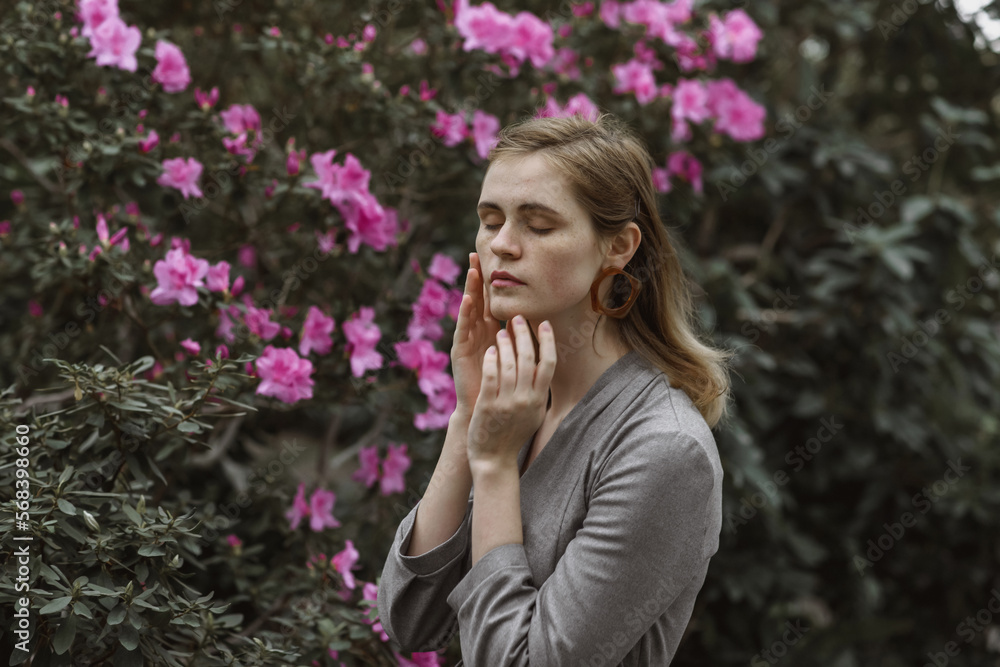 A girl poses in a botanical garden among plants A girl poses in a botanical garden among plants