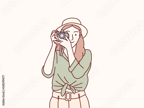 smiling Woman wear hat photographer is taking images photo with dslr camera simple korean style illustration