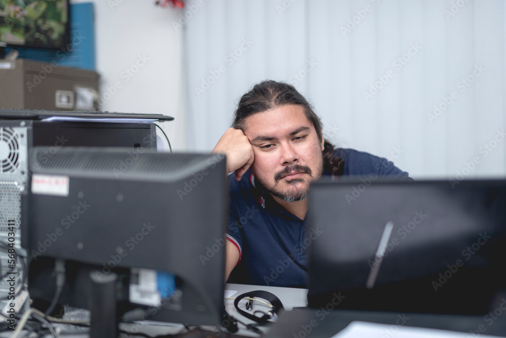 A jaded man looking listlessly at the camera. Lack of sleep affecting work productivity. A jaded man looking listlessly at the camera. Lack of sleep affecting work productivity.